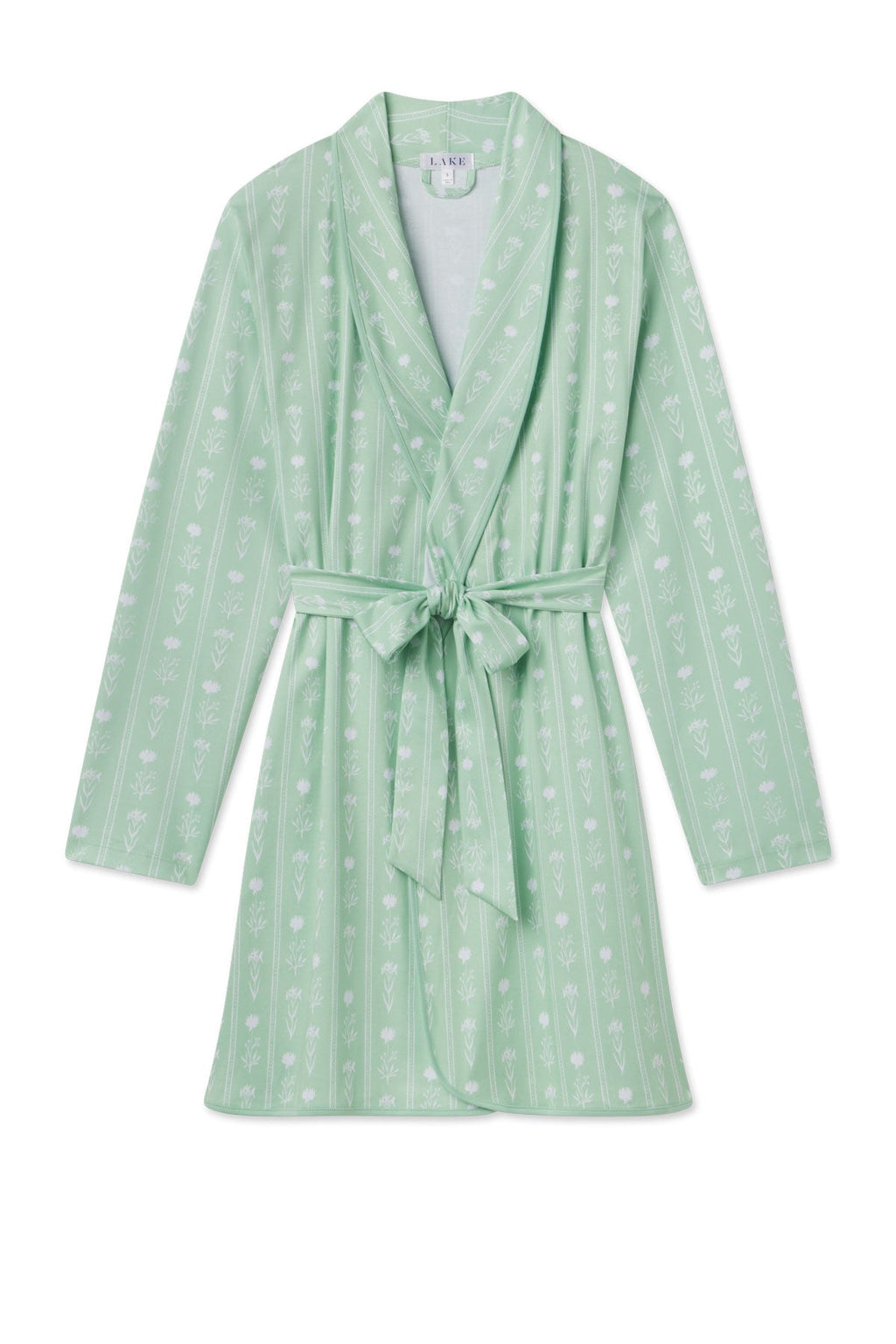 The Pima Short Robe in Parisian Green Watercolor Stems boasts a lovely floral pattern with vertical stripes, long sleeves, a shawl collar, and a waist belt. Made from luxurious Pima cotton, it ensures comfort and elegance.